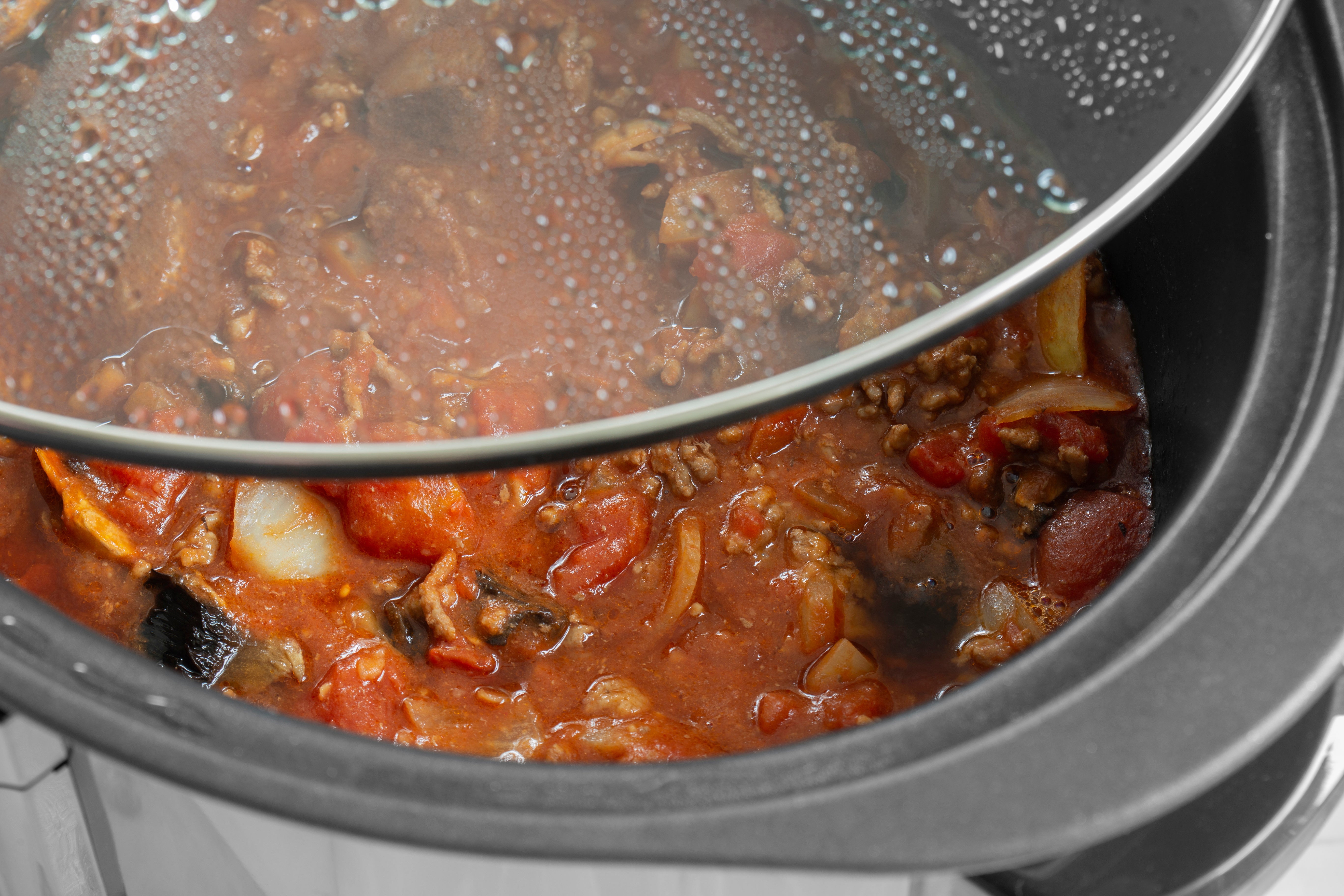 crockpot with lid, filled with chili