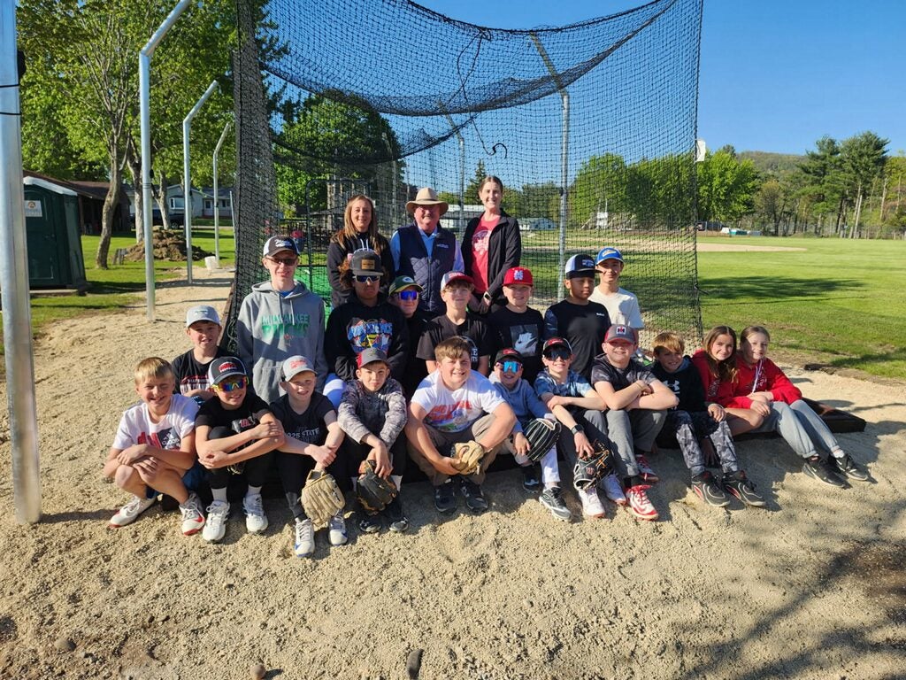 Director Bryce Lisowski with a group of ball players at the new batting cages we made a donation towards. 